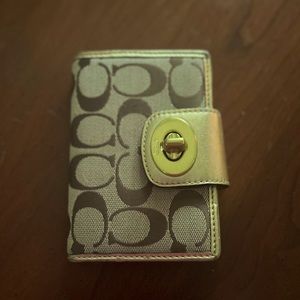 Coach gold wallet.